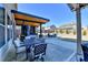 Inviting backyard patio featuring a stylish outdoor dining set and covered hot tub area at 3488 In Bloom Way, Auburn, GA 30011