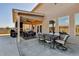 Backyard patio featuring an outdoor stone fireplace and comfortable seating area at 3488 In Bloom Way, Auburn, GA 30011