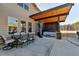 Backyard patio featuring a covered hot tub area, and outdoor dining table set at 3488 In Bloom Way, Auburn, GA 30011