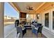 Covered outdoor patio area features a fireplace and stylish outdoor seating at 3488 In Bloom Way, Auburn, GA 30011