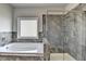 Beautiful bathroom showcasing a glass enclosed shower and separate soaking tub at 3488 In Bloom Way, Auburn, GA 30011