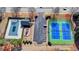 Aerial view featuring the community pool, playground, and tennis courts surrounded by landscaped areas at 3488 In Bloom Way, Auburn, GA 30011