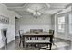 Elegant dining room with coffered ceiling, wainscoting, and abundant natural light at 3488 In Bloom Way, Auburn, GA 30011