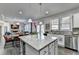 Open kitchen showcases island, stainless appliances, granite counters, and modern finishes at 3488 In Bloom Way, Auburn, GA 30011