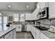 Well-equipped kitchen with stainless steel appliances, granite countertops, and ample cabinetry at 3488 In Bloom Way, Auburn, GA 30011