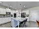 Lovely kitchen featuring a granite island, stainless appliances, white cabinets, and pantry at 3488 In Bloom Way, Auburn, GA 30011