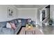 Comfortable living room showcasing a sectional sofa, modern coffee table, and staircase access at 3488 In Bloom Way, Auburn, GA 30011