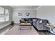 Cozy living room features a plush sectional sofa, stylish coffee table, and neutral decor at 3488 In Bloom Way, Auburn, GA 30011