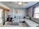 Upstairs living room features a large sectional, a ceiling fan, and cool wall art at 3488 In Bloom Way, Auburn, GA 30011