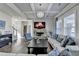 Elegant living room boasts coffered ceilings, stone fireplace, and large windows at 3488 In Bloom Way, Auburn, GA 30011