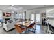 Bright living space with a dining table and a view of the fireplace and Gathering room at 3488 In Bloom Way, Auburn, GA 30011