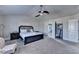 Comfortable main bedroom showcasing a ceiling fan, carpet flooring and neutral tones at 3488 In Bloom Way, Auburn, GA 30011