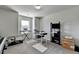 Bright office with a window and gray carpet includes a desk and shelving unit at 3488 In Bloom Way, Auburn, GA 30011