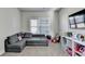 Playroom with a comfortable sofa, plush carpeting, and storage at 3488 In Bloom Way, Auburn, GA 30011