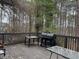 Wooden deck with a grill and table, perfect for outdoor entertaining and relaxation at 911 Laurel Crest Dr, Woodstock, GA 30189