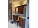 Bathroom with double vanity, granite countertops, and dark wood cabinets at 911 Laurel Crest Dr, Woodstock, GA 30189