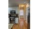 Kitchen featuring stainless steel appliances, hardwood floors, and white cabinets at 911 Laurel Crest Dr, Woodstock, GA 30189