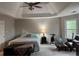Spacious main bedroom with a tray ceiling, carpet flooring, and a comfortable bed at 911 Laurel Crest Dr, Woodstock, GA 30189