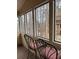 Enclosed porch featuring three picture windows, a wood floor, and two chairs at 911 Laurel Crest Dr, Woodstock, GA 30189