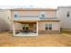 View of the back of the house with a covered back patio and neutral colored siding at 1187 Kingston Hill Dr, Loganville, GA 30052