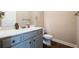 Well-lit half bath with modern vanity, mirror, and fixtures at 1187 Kingston Hill Dr, Loganville, GA 30052
