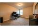 Bedroom with carpet, desk, rolling office chair, dresser, and window providing lots of natural light at 1187 Kingston Hill Dr, Loganville, GA 30052