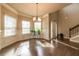 Formal dining room with dark hardwood floors, decorative molding, and modern chandelier at 1187 Kingston Hill Dr, Loganville, GA 30052