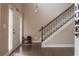 Light and airy entryway with hardwood floors and staircase with decorative iron railing at 1187 Kingston Hill Dr, Loganville, GA 30052