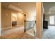 A hallway with carpeted floor, neutral walls, and access to a bathroom, bedrooms, and upper level at 1187 Kingston Hill Dr, Loganville, GA 30052