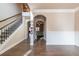 Spacious hallway with hardwood floors, decorative molding, and arched doorways at 1187 Kingston Hill Dr, Loganville, GA 30052