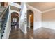 Spacious hallway with hardwood floors, decorative molding, and arched doorways at 1187 Kingston Hill Dr, Loganville, GA 30052