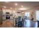Bright kitchen with stainless steel appliances, granite countertops, gray cabinets, and island with seating for four at 1187 Kingston Hill Dr, Loganville, GA 30052