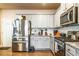 Modern kitchen showcases stainless steel appliances, granite countertops, subway tile backsplash, and abundant cabinet space at 1187 Kingston Hill Dr, Loganville, GA 30052
