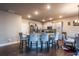 Spacious kitchen features granite countertops, stainless appliances, island with seating, and an adjacent dining area at 1187 Kingston Hill Dr, Loganville, GA 30052