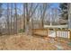 Large wooden deck leads to concrete patio with mature trees and shade at 3815 Glen Laurel Ct, Cumming, GA 30040