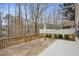 Wood deck and partial concrete patio surrounded by mature trees offers a peaceful outdoor space at 3815 Glen Laurel Ct, Cumming, GA 30040