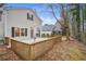 Backyard featuring a spacious wooden deck, mature trees, and the back of the house with neutral vinyl siding at 3815 Glen Laurel Ct, Cumming, GA 30040