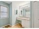 Bathroom featuring a vanity and a large mirror with soft blue walls at 3815 Glen Laurel Ct, Cumming, GA 30040