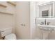 Cozy bathroom with unique pedestal sink, shelf storage, and stylish light fixture at 3815 Glen Laurel Ct, Cumming, GA 30040