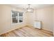Cozy dining area with hardwood floors, modern light fixture, and a charming cabinet at 3815 Glen Laurel Ct, Cumming, GA 30040