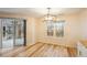 Bright dining area featuring hardwood floors, modern lighting, and access to a sunroom at 3815 Glen Laurel Ct, Cumming, GA 30040
