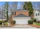 Front of home with brick and siding, attached garage, landscaping, and a mailbox at 3815 Glen Laurel Ct, Cumming, GA 30040