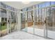 Sunroom with floor-to-ceiling windows and marble floors overlooking backyard deck at 3815 Glen Laurel Ct, Cumming, GA 30040