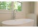 Freestanding tub with modern chrome fixtures and a window at 114 Terrace Ne Dr, Atlanta, GA 30305