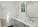 Bright bathroom featuring a double vanity with quartz countertop and modern fixtures at 114 Terrace Ne Dr, Atlanta, GA 30305
