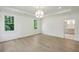 Spacious bedroom with hardwood floors, bright windows, and a view into an adjacent bathroom at 114 Terrace Ne Dr, Atlanta, GA 30305