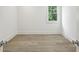 Bedroom featuring hardwood floors, bright white walls, and modern door hardware at 114 Terrace Ne Dr, Atlanta, GA 30305