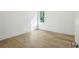 Bright bedroom with hardwood floors, white walls, and a window providing natural light at 114 Terrace Ne Dr, Atlanta, GA 30305