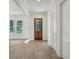 Bright foyer with hardwood floors, transom window and white trim throughout at 114 Terrace Ne Dr, Atlanta, GA 30305