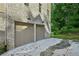 Exterior view of a two car garage with brick siding and dark metal lighting at 114 Terrace Ne Dr, Atlanta, GA 30305